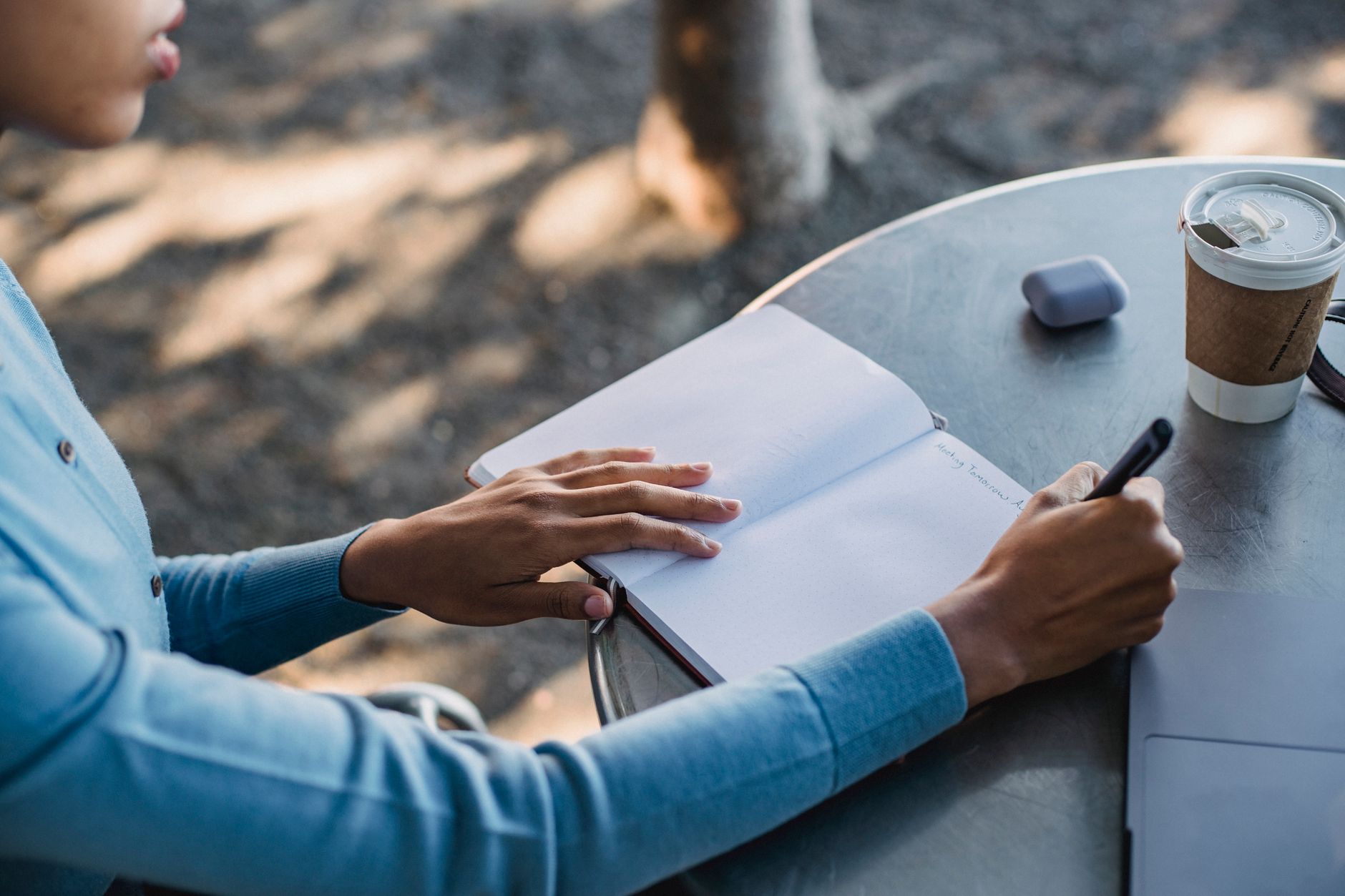 Travel writer taking notes in café